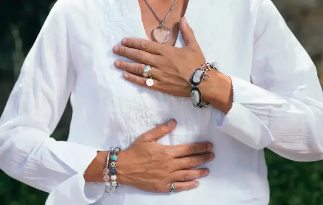 Person practicing breathwork and somatic techniques to regulate the nervous system and release trauma through intentional breathing.